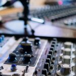 オーディオミキサーのフェーダーとつまみのクローズアップ